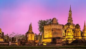 Iconic Buddha statues in Sukhothai for a vibrant Sukhothai Tours banner with Legend Travel Group.